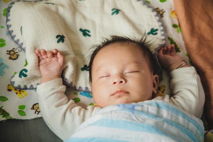 asian baby sleeping peacefully in a crib