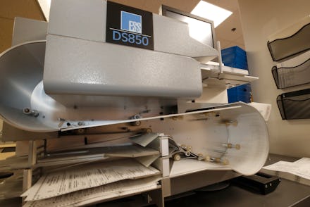 PROVO, UT - JUNE 30: A high speed counting machine processes cast ballots at the Utah County electio...