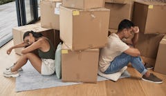 two roommates who might have a toxic relationship surrounded by boxes in their apartment.