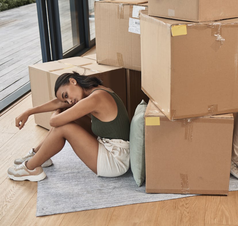 two roommates who might have a toxic relationship surrounded by boxes in their apartment.