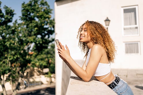 woman outside with her phone