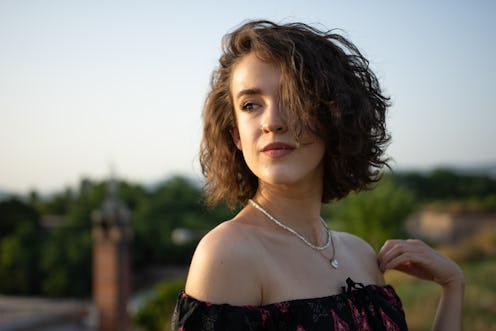 Young beautiful woman enjoying enjoys the sunset