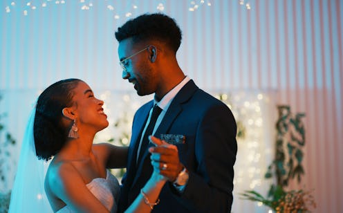 Cropped shot of a happy newlywed couple dancing together at their reception dinner after their weddi...