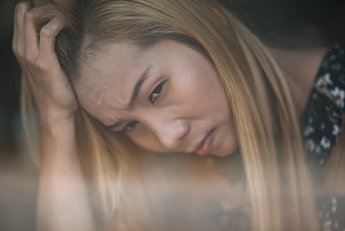 Portrait stressed sad young woman sitting at cafe