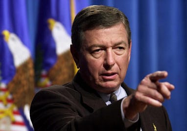 US Attorney General John Ashcroft points a reporter 18 October 2001 during a press conference at the...
