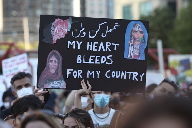 Dozens of Afghan gathered for a rally in solidarity with their countrymen on Sunday, on August 15, 2...