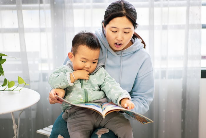 Mother with son reading a book together