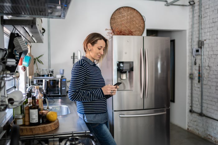 woman texting on the phone at home