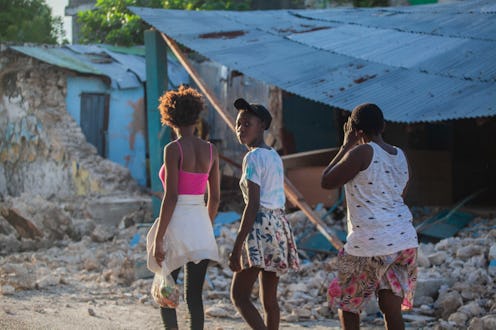 Haitians walk the street after a 7.2-magnitude earthquake on August 15, 2021. Here are places to don...