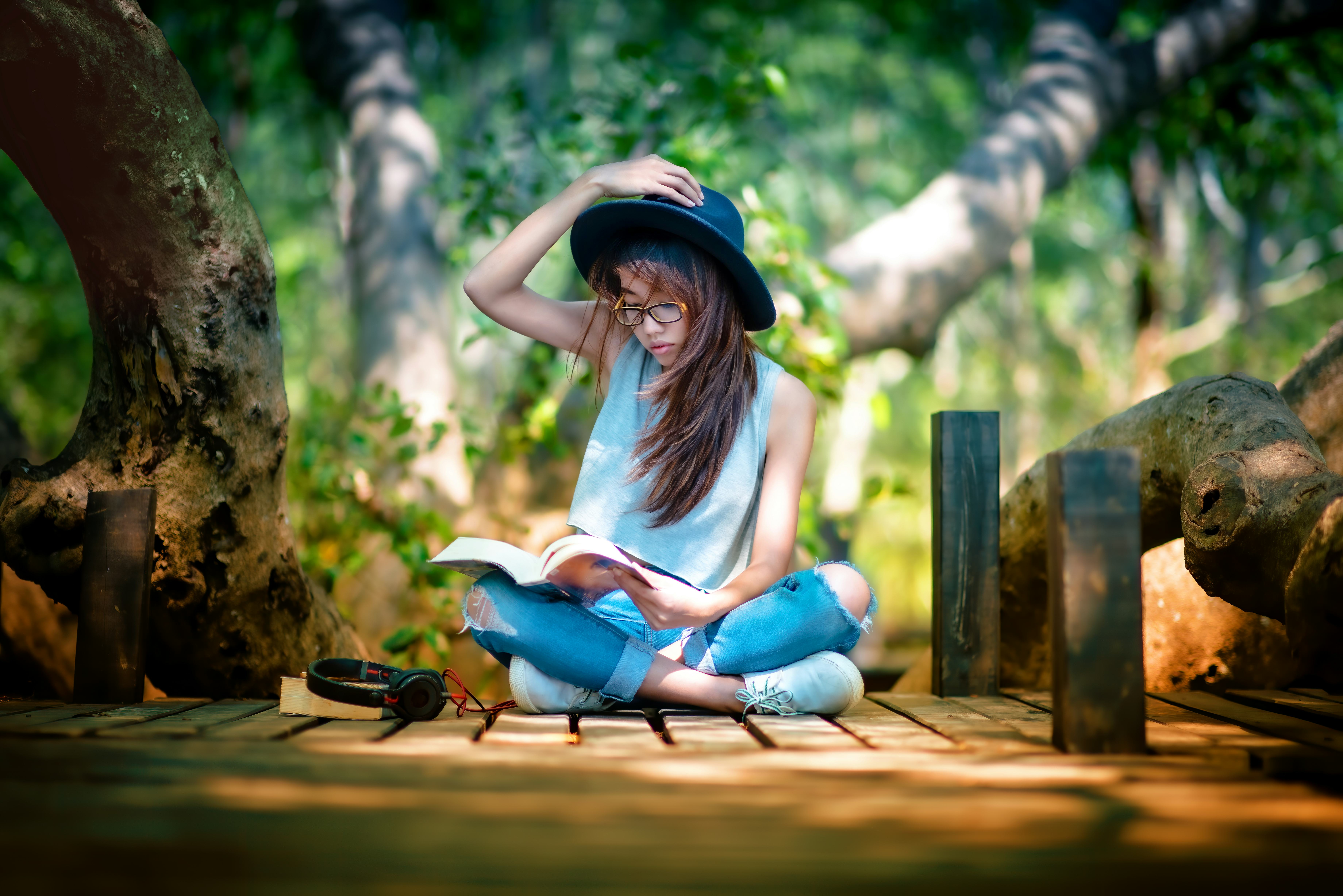 Woman enjoy nature resting relax after reading book in garden public park in the light of morning ch...