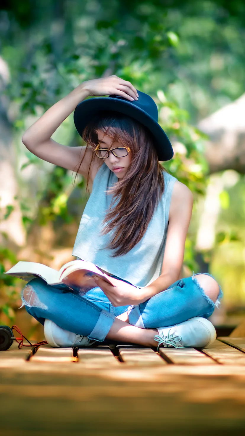 Woman enjoy nature resting relax after reading book in garden public park in the light of morning ch...