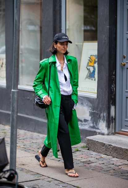 COPENHAGEN, DENMARK - AUGUST 10: Ilenia Toma seen wearing green coat, Celine cap outside The Garment...