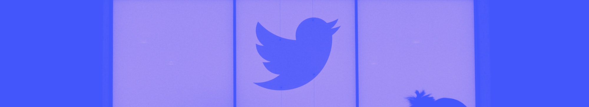 Employees walk past a lighted Twitter log as they leave the company's headquarters in San Francisco ...