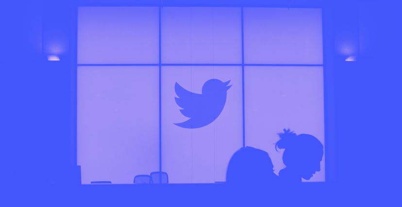 Employees walk past a lighted Twitter log as they leave the company's headquarters in San Francisco ...