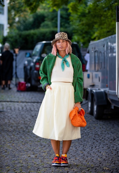 COPENHAGEN, DENMARK - AUGUST 11: Karin Teigl seen wearing hat, skirt, top, green jacket, orange bag ...