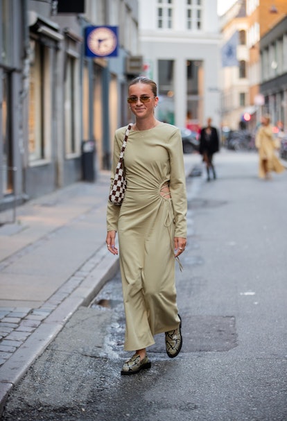COPENHAGEN, DENMARK - AUGUST 10: A guest is seen wearing olive dress outside Soeren Le Schmidt on Au...