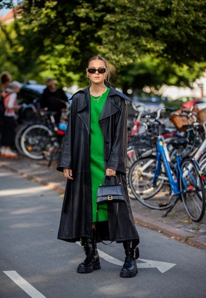 COPENHAGEN, DENMARK - AUGUST 11: Alessa Winter seen wearing green dress, black coat, Balenciaga bag,...