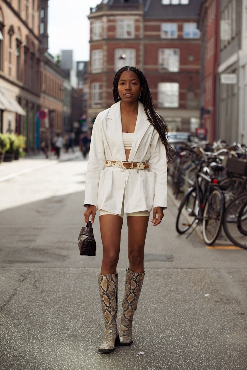 COPENHAGEN, DENMARK - AUGUST 11: Bria Jones wearing light short shorts, crop top, blazer with a belt...