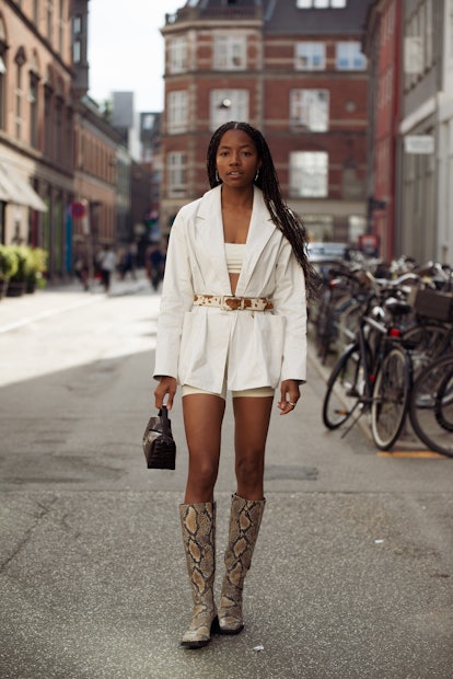 COPENHAGEN, DENMARK - AUGUST 11: Bria Jones wearing light short shorts, crop top, blazer with a belt...
