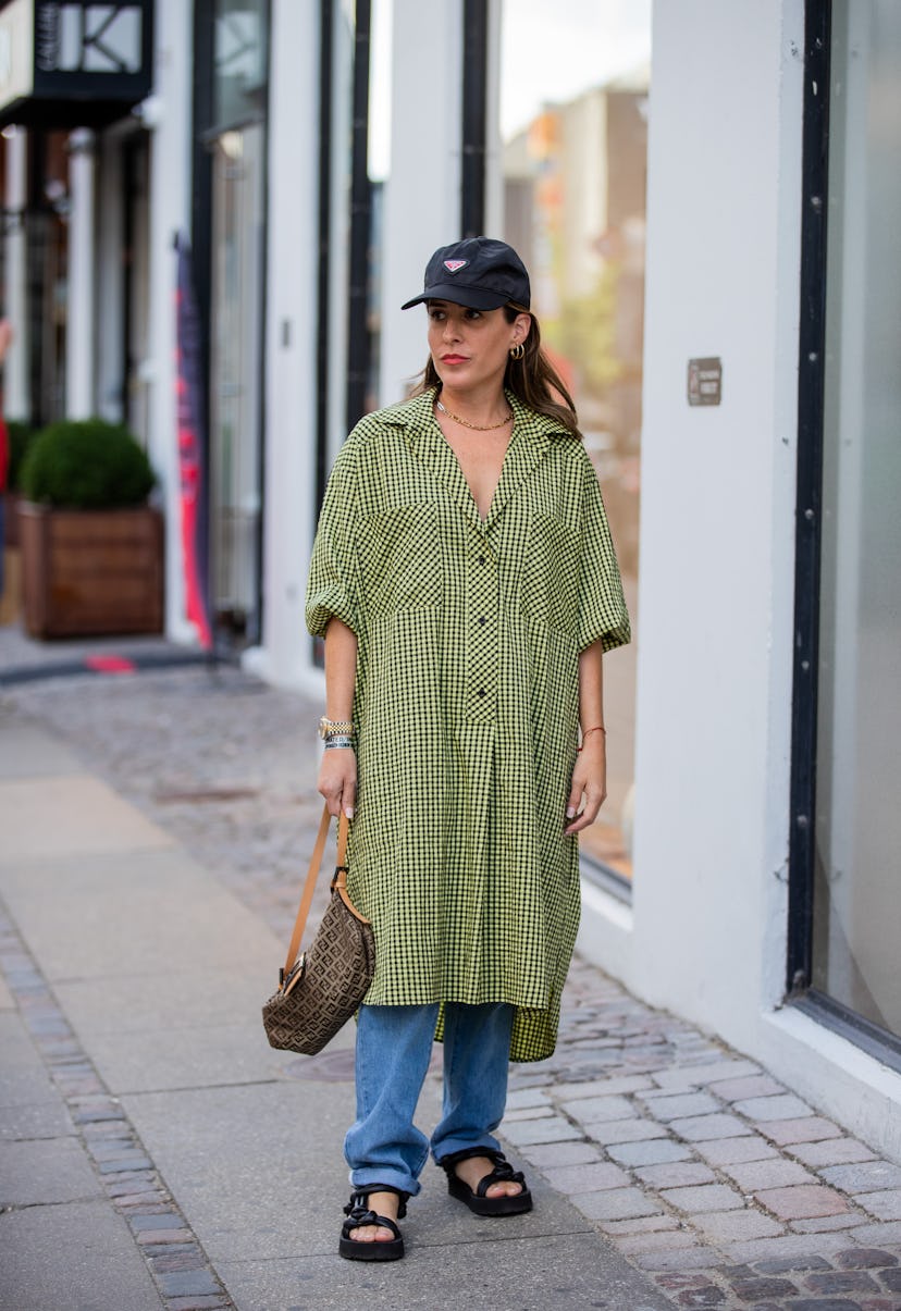 COPENHAGEN, DENMARK - AUGUST 11: Idalia Salsamendi wearing Prada cap, green button up dress outside ...