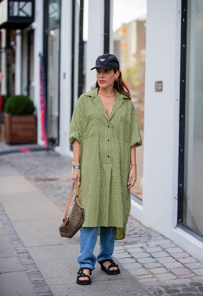 COPENHAGEN, DENMARK - AUGUST 11: Idalia Salsamendi wearing Prada cap, green button up dress outside ...