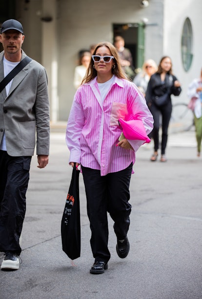 COPENHAGEN, DENMARK - AUGUST 10: A guest is seen wearing pink striped button shirt outside (di)visio...