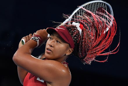 Japan's Naomi Osaka returns the ball to Czech Republic's Marketa Vondrousova during their Tokyo 2020...
