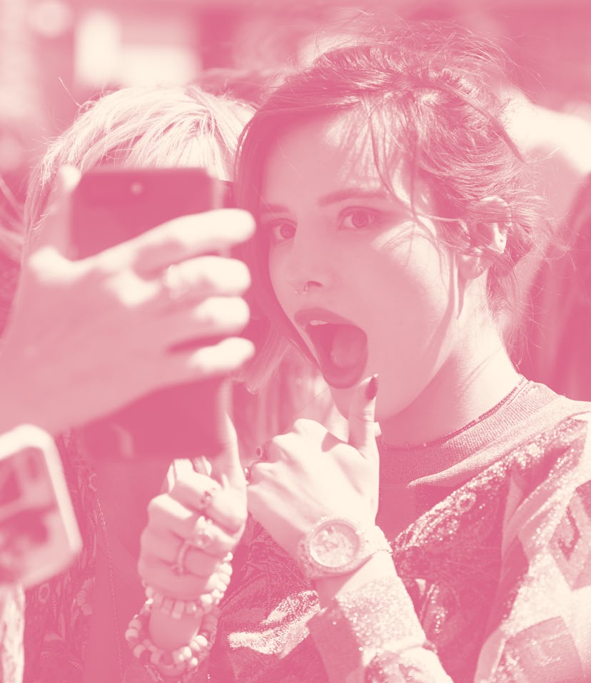 UNIVERSAL CITY, CA - MARCH 27: Bella Thorne takes selfies with fans at "Extra" at Universal Studios...