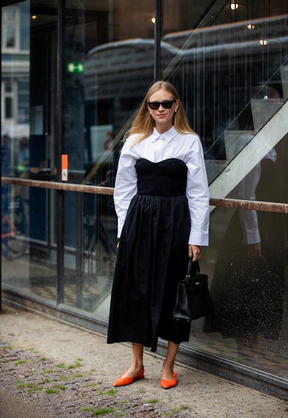 COPENHAGEN, DENMARK - AUGUST 10: Tine Andrea is seen wearing black dress, white button shirt outside...