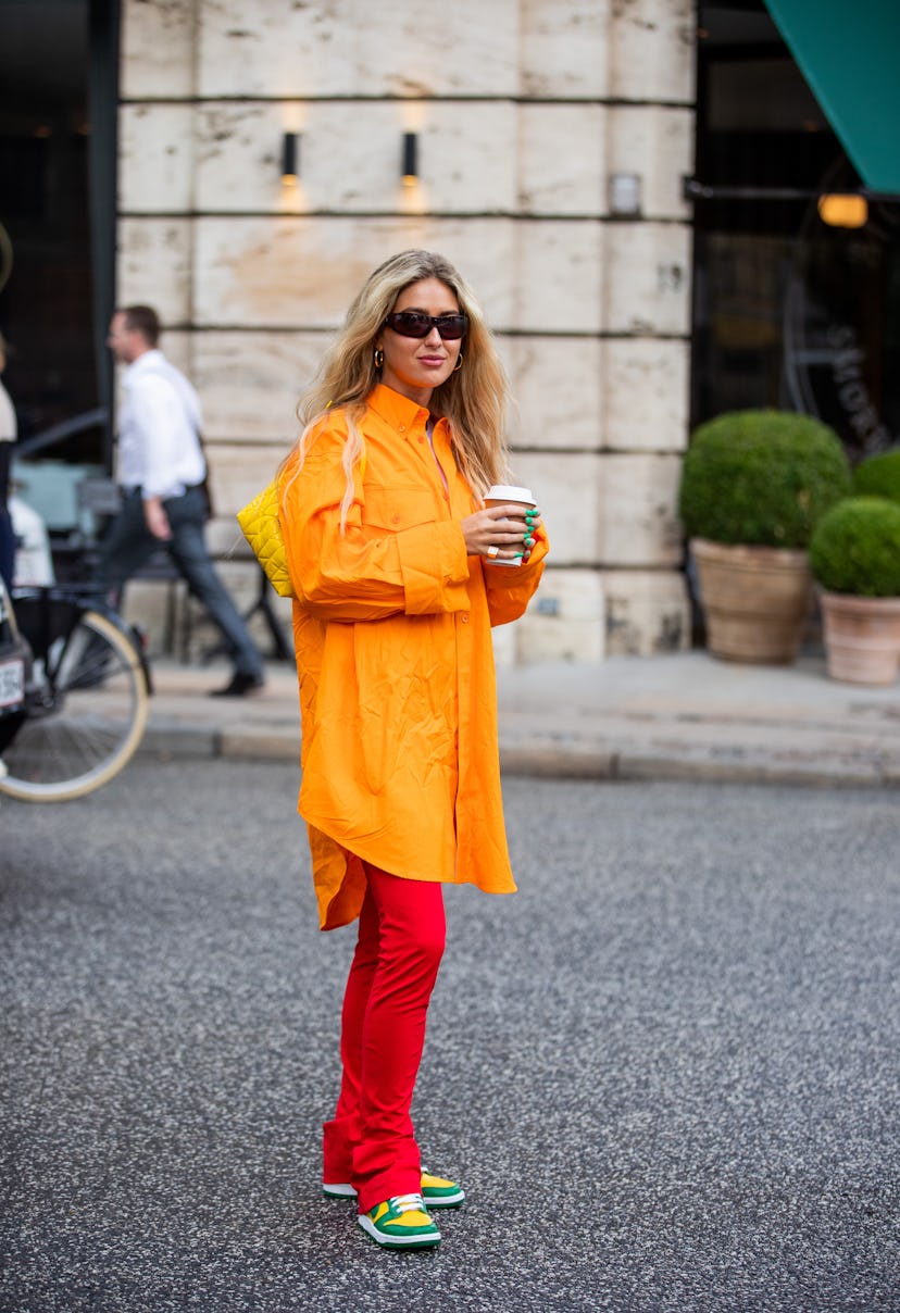 COPENHAGEN, DENMARK - AUGUST 10: Emili Sindlev seen wearing orange jacket, red pants outside The Gar...