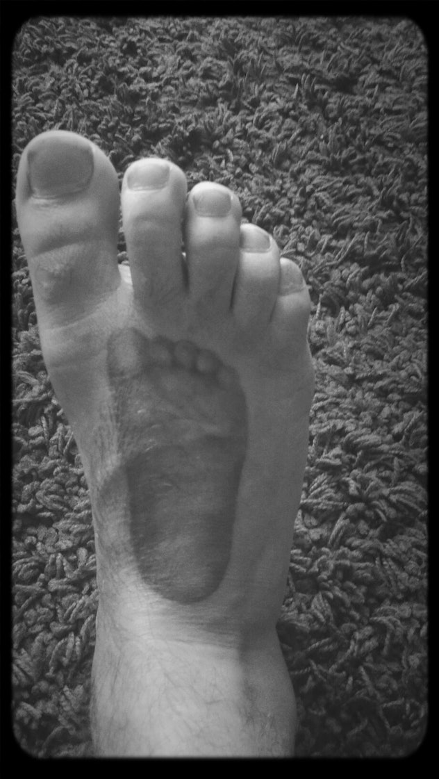 Baby footprint tattoo on foot.