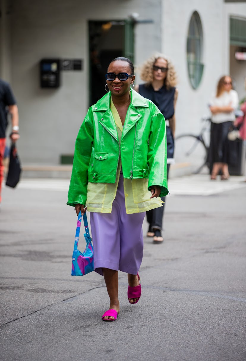 COPENHAGEN, DENMARK - AUGUST 10: A guest is seen wearing green jacket, pink cropped pants outside (d...