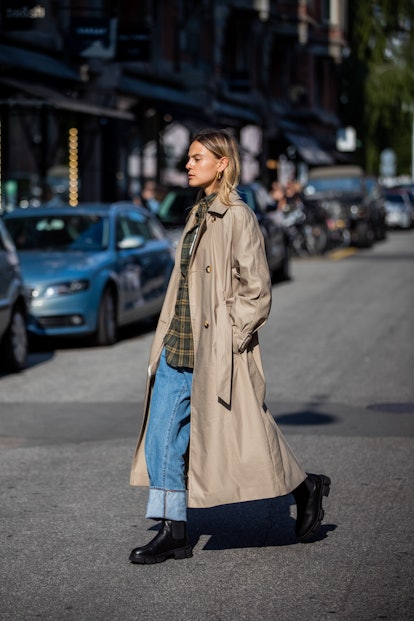 COPENHAGEN, DENMARK - AUGUST 12: Alessa Winter seen wearing denim jeans, trench coat in beige, black...