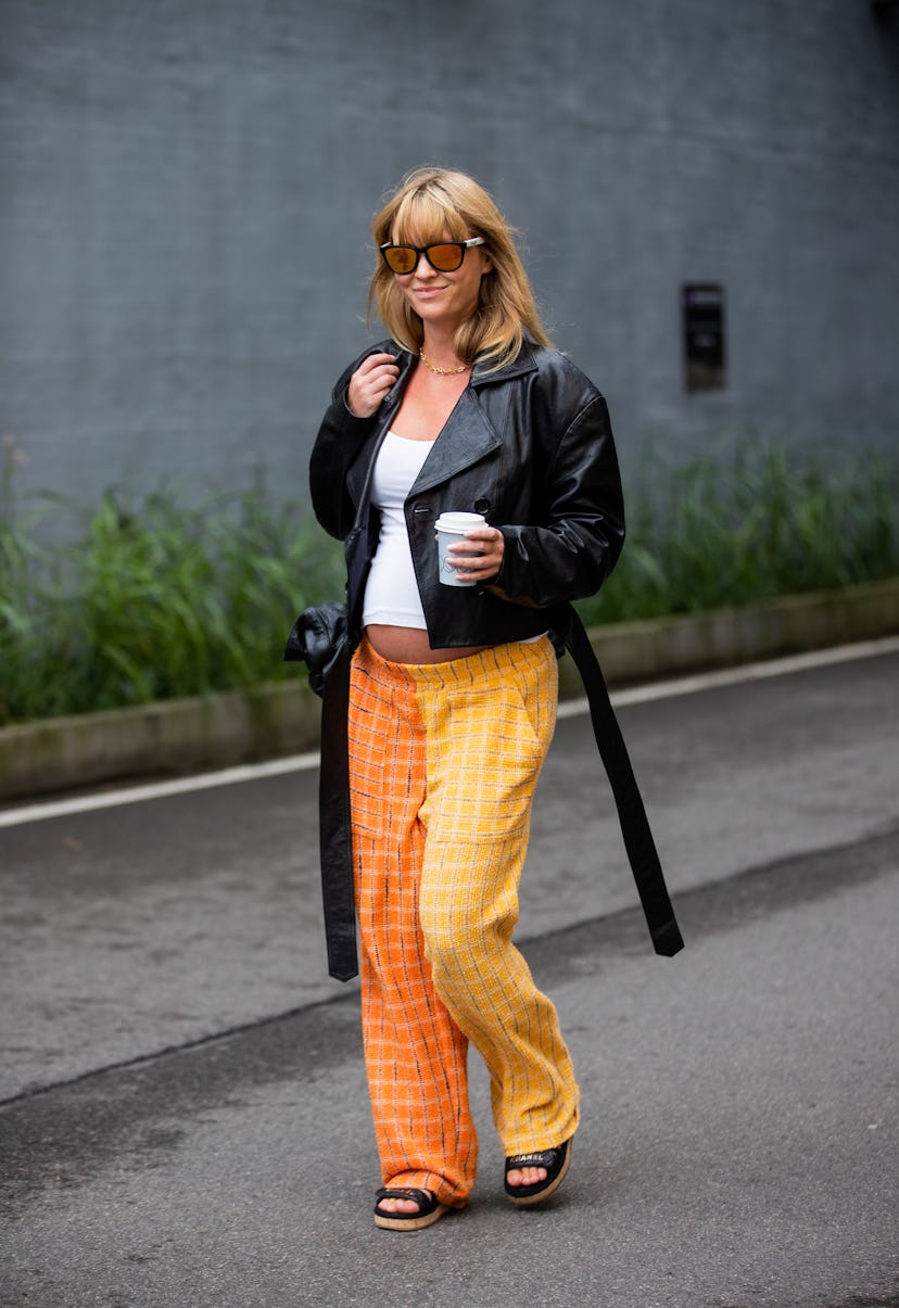 COPENHAGEN, DENMARK - AUGUST 10: Jeanette Friis Madsen is seen wearing orange pants, black jacket ou...