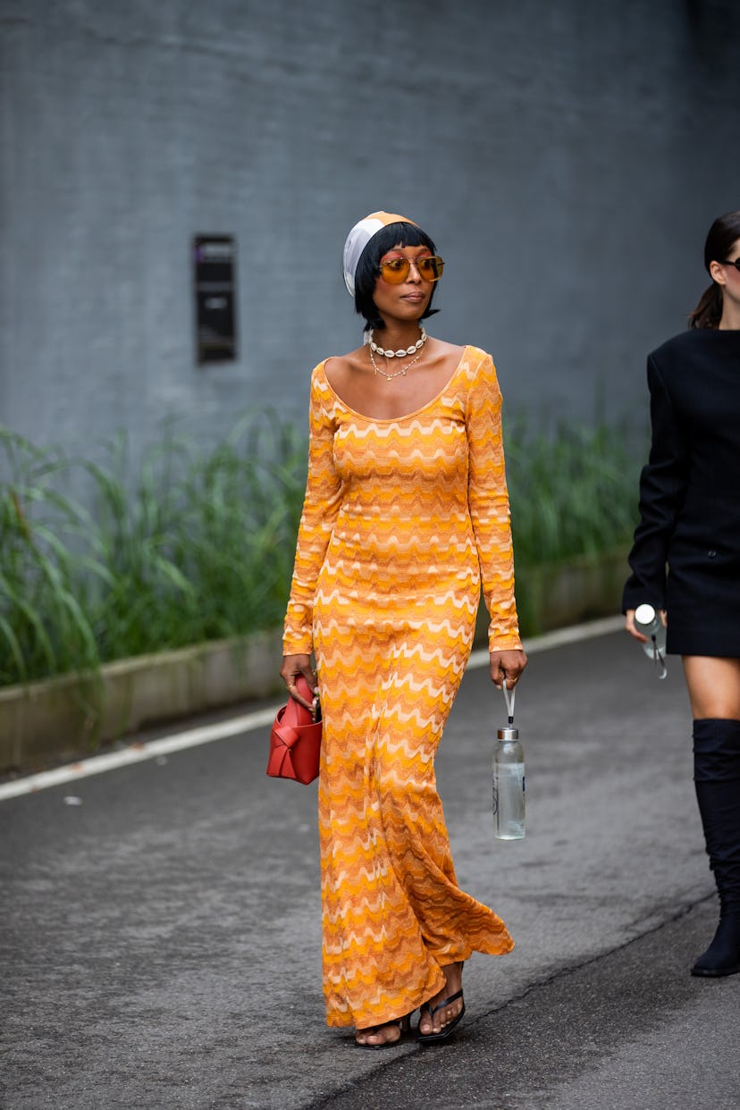 COPENHAGEN, DENMARK - AUGUST 10: A guest is seen wearing orange dress, head scarf outside (di)vision...