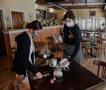 West Reading, PA - May 5: Hostess Kayla Lipari, and server Ana Garcia, clear a table at Say Cheese! ...