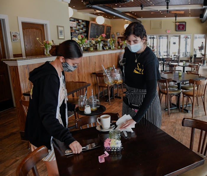 West Reading, PA - May 5: Hostess Kayla Lipari, and server Ana Garcia, clear a table at Say Cheese! ...