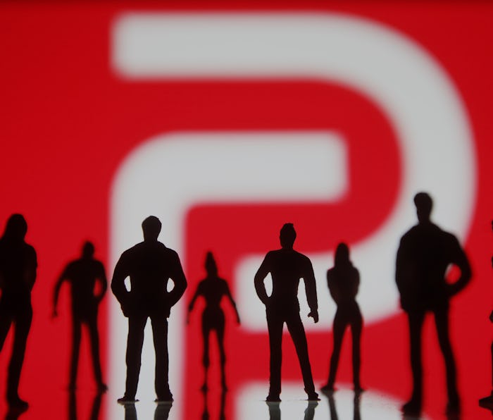UKRAINE - 2021/01/10: In this photo illustration the Parler logo seen in front of the silhouettes of...