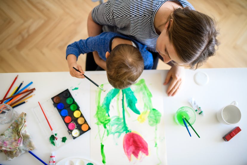 Image of adult and child painting flowers together.