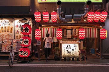 OSAKA, JAPAN - AUGUST 02: A customer wearing a protective face mask leaves after dining at a restaur...
