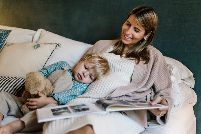 Child resting on mom because breastfeeding during pregnancy can be difficult with supply dips.