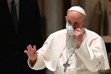 Pope Francis gestures as he adjusts his facemask during his weekly general audience at Paul VI hall ...