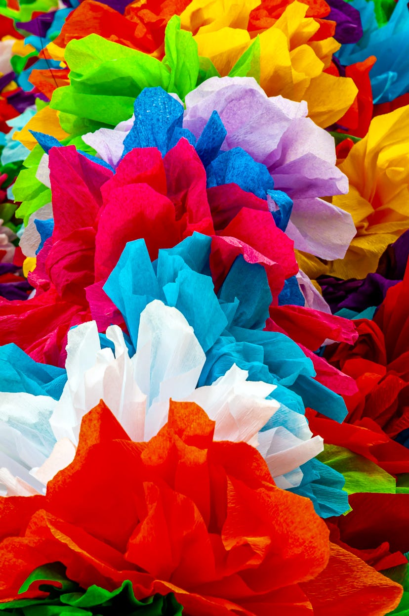 An image of a collection of colorful flowers made from tissue paper.