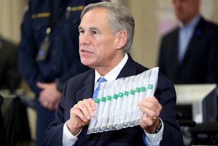 ARLINGTON, TEXAS - MARCH 18: Texas Governor Greg Abbott displays COVID-19 test collection vials as h...