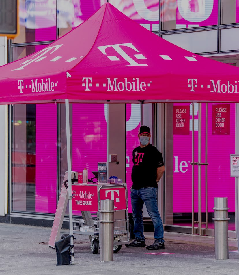NEW YORK, NEW YORK - AUGUST 18: A clerk at the T-Mobile store in Times Square provides curb side ser...