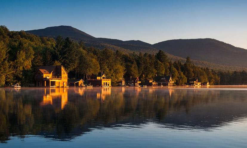 Wooden cabins around mountain town Lake Placid, NY, USA in early morning