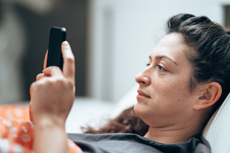 woman text messaging in the bed