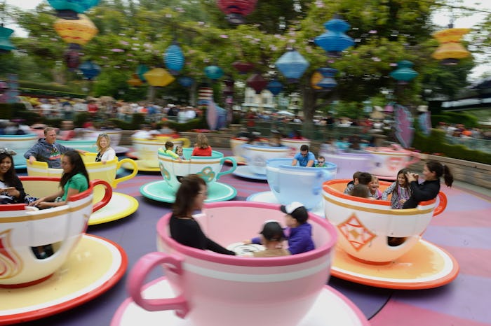 guests at disneyland spinning in tea cup ride