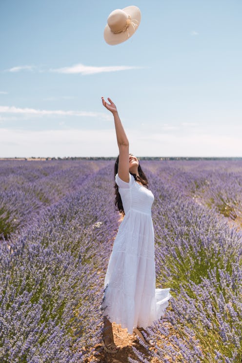 A woman in a lavender field tosses her hat in the air, free from the tyranny of social media. Here's...