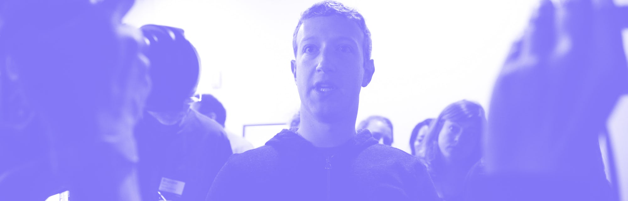 Mark Zuckerberg (center) speaks to a media after a press conference where a redesign of Facebook's ...
